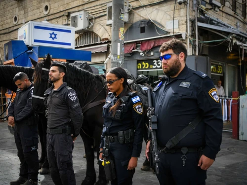 People stand still in outside the Mahane Yehuda Market in Jerusalem, as a two-minute siren is sounded across Israel to mark Holocaust Remembrance Day on April 24, 2025. Photo by Arie Leib Abrams/Flash90.