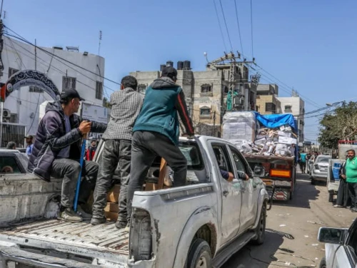 Armed and masked Palestinians on trucks loaded with humanitarian aid entering southern Gaza through the Kerem Shalom Crossing from Israel, April 3, 2024. Photo by Abed Rahim Khatib/Flash90.