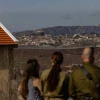 Israelis in Metula view damage from an IDF operation across the border in Lebanon, Dec. 9, 2024. Photo by Chaim Goldberg/Flash90.