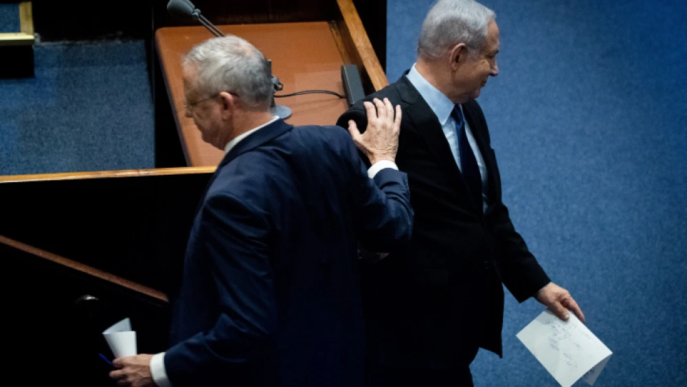 Blue and White Party leader Benny Gantz passes Israeli Prime Minister Benjamin Netanyahu at a memorial ceremony in the Knesset marking 24 years since the assassination of former Israeli Prime Minister Yitzhak Rabin, on Nov. 10, 2019. Photo by Yonatan Sindel/Flash90.