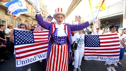 A Christian evangelical supporter waves during the annual parade in Jerusalem, marking the Jewish holiday of Sukkot (“The Feast of the Tabernacles”). Credit: Abir Sultan/Flash90.