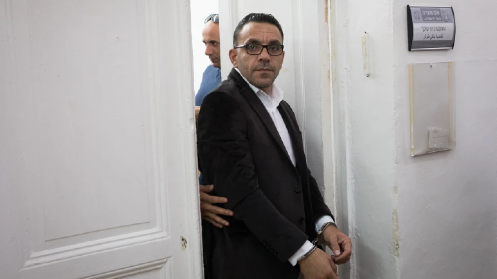 Palestinian Authority Jerusalem “governor” Adnan Ghaith is escorted by police after a court hearing at the Magistrate's Court in Jerusalem on Nov. 25, 2018. Photo by Yonatan Sindel/Flash90.