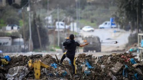A Palestinian boy readies to throw a stone at Israeli security forces during a protest in the village of Beita, near the city of Nablus, Jan. 28, 2023. Credit: Nasser Ishtayeh/Flash90.