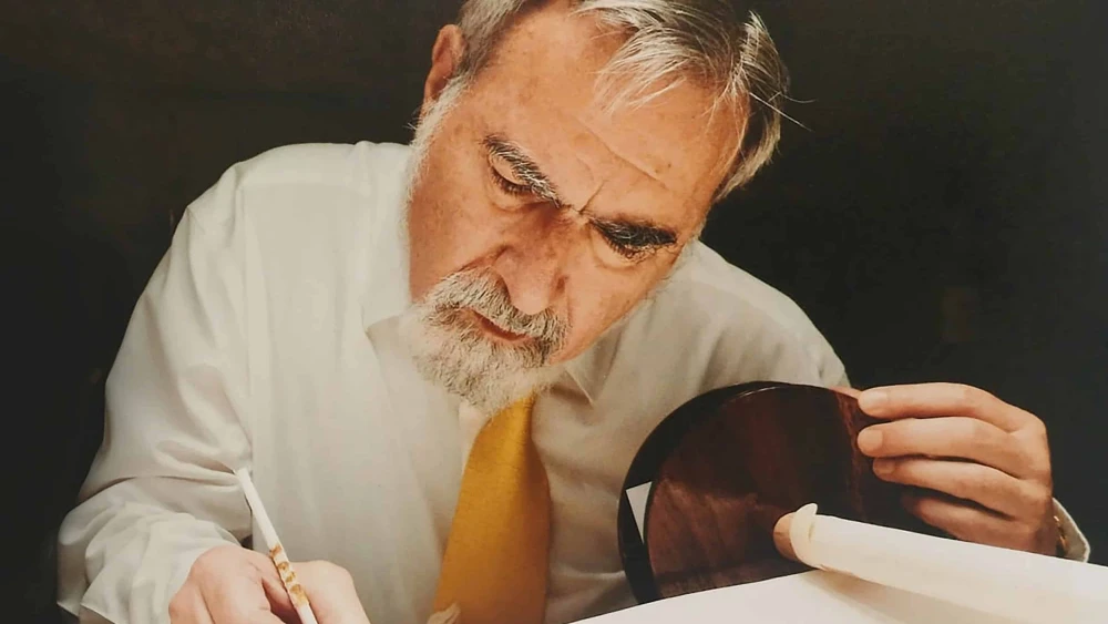 Rabbi Jonathan Sacks writing in the Torah. Credit: Rabbi Sacks Legacy.