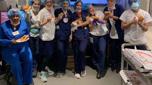 Health-care professionals at New York-Presbyterian Hospital enjoy kosher pizza delivered by Kosher19. Credit: Courtesy.