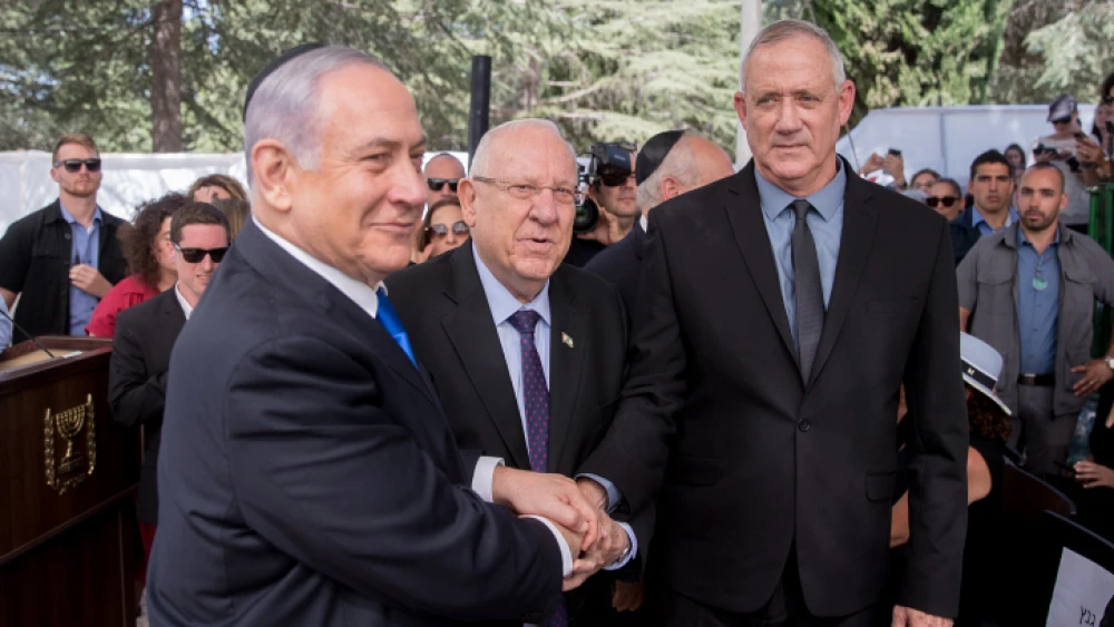 From left: Israel’s President Reuven Rivlin, Israeli Prime Minister Benjamin Netanyahu and Blue and White Party leader Benny Gantz, shake hands at the memorial ceremony for the late President Shimon Peres, at the Mount Herzl cemetery in Jerusalem, on Sept. 19, 2019. Photo by Yonatan Sindel/Flash90.