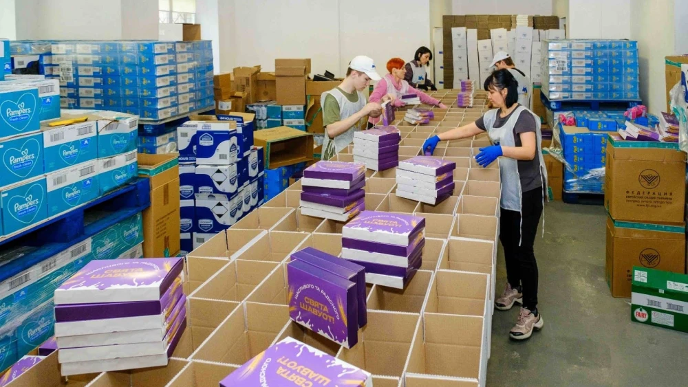 Staff prepare Shavuot packages for Ukrainian Jews in May 2025. Photo credit: FJCU.
