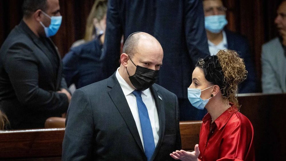 Israeli Prime Minister Naftali Bennett speaks with Knesset member Idit Silman in the plenary hall of the parliament in Jerusalem, Jan. 5, 2022. Photo by Yonatan Sindel/Flash90.