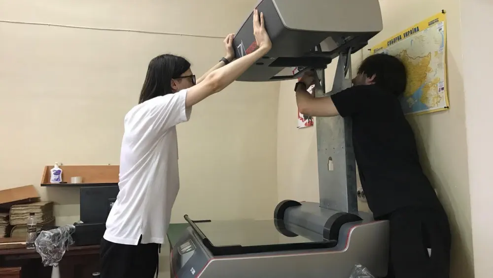 Staff members at the Central State Historical Archives of Ukraine in Lviv prepare to use the donated scanner. Credit: Courtesy of JewishGen.