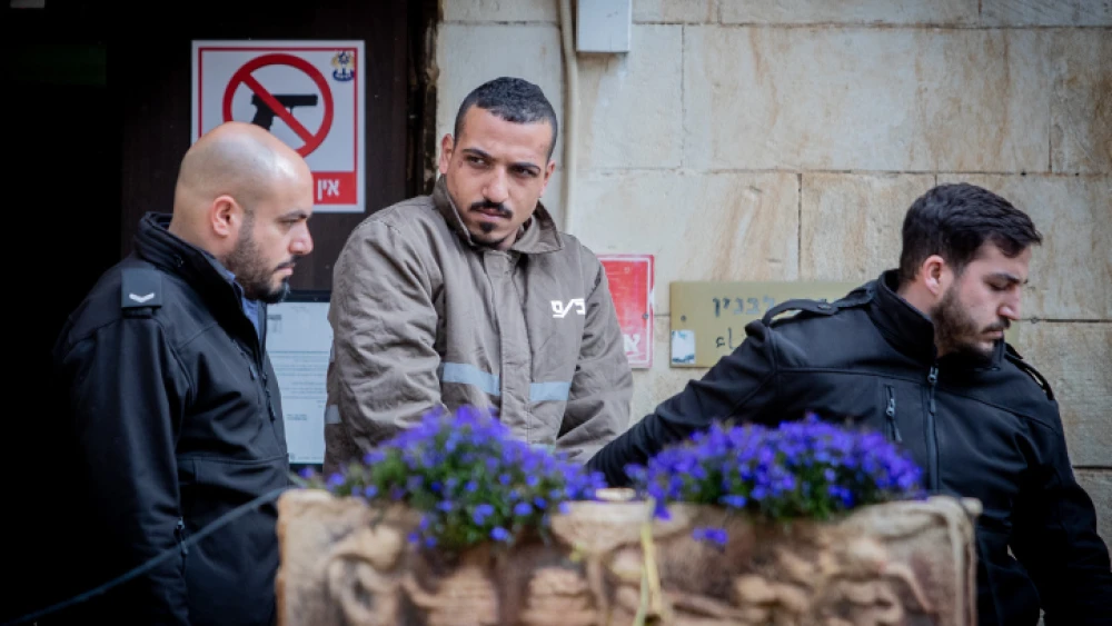 Sanad al-Turman, the suspect in the car-ramming attack in Jerusalem on Feb. 6, 2020, is escorted by prison guards outside the Jerusalem Magistrate's Court on Feb. 7, 2020. Photo by Yonatan Sindel/Flash90.