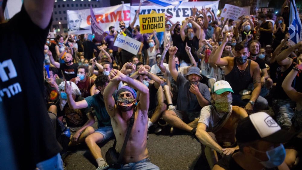 As the ongoing effects of the coronavirus and lockdowns have affected the economy, protesters block a road in Tel Aviv, calling for financial support from the Israeli government on July 11, 2020. Photo by Miriam Alster/Flash90.