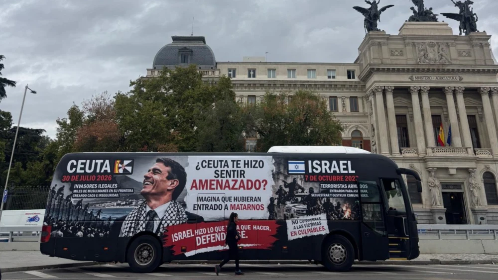 A bus carrying a billboard created by Action and Communication on the Middle East about the Ceuta crisis and the Hamas-led massacres of Oct. 7, 2023, drives through Madrid, Oct. 6, 2026. Credit: Courtesy of ACOM.
