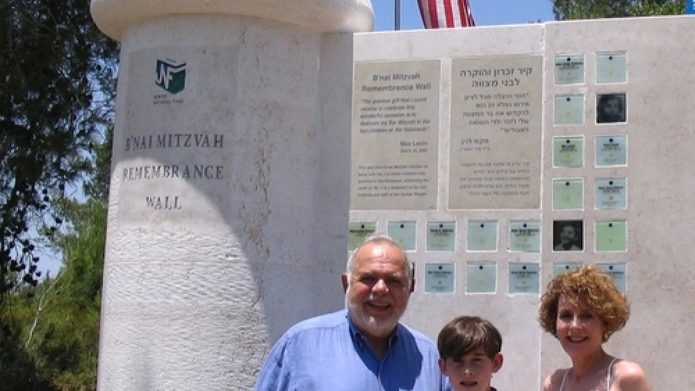 Max Levin with his parents Judy and Bud in front of the B’nai Mitzvah Remembrance Wall, located in the Jerusalem hills near Beit Shemesh. Credit: Jewish National Fund.