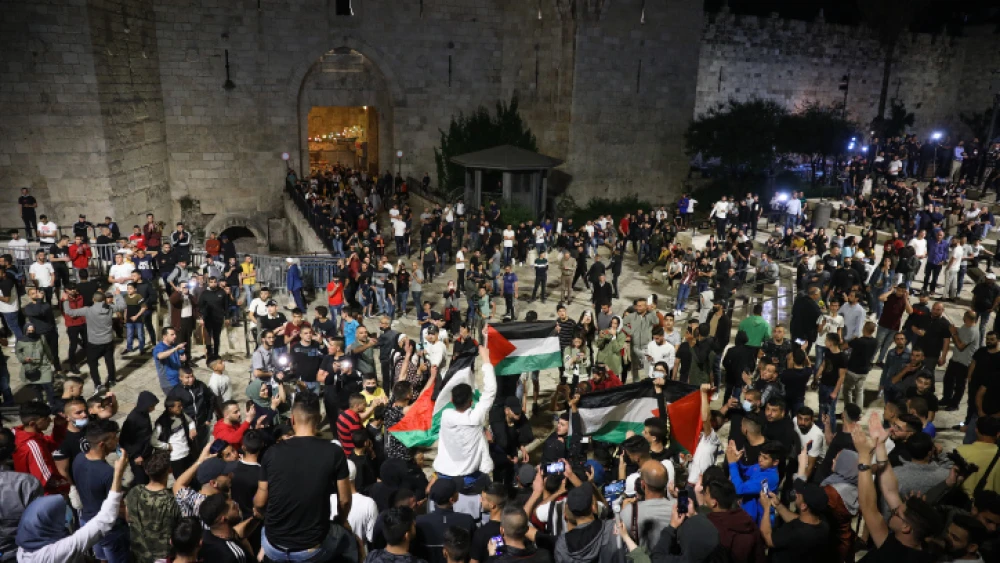 Arabs wave Palestinians flags at Damascus Gate in Jerusalem's Old City, April 25, 2021. Photo by Noam Revkin Fenton/Flash90.