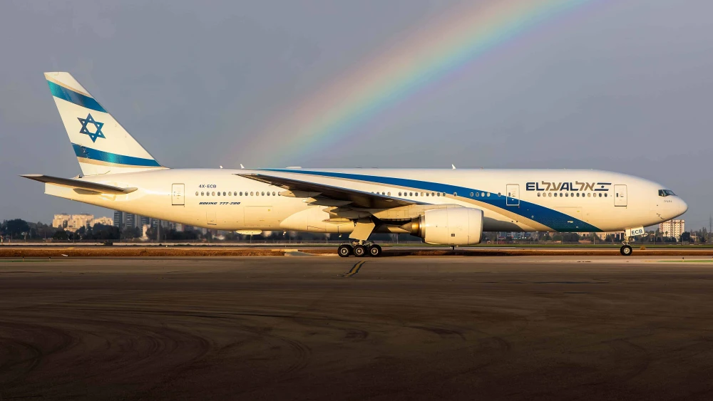 An El Al plane on the runway of Ben-Gurion International Airport with a rainbow in the background. Credit: Courtesy.