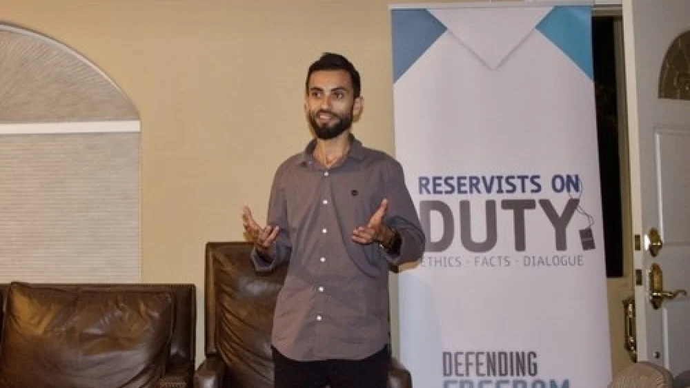 A representative of Reservists on Duty (RoD) speaks Monday night at Stanford Chabad as part of a program highlighting the stories of Israeli minorities. After the Stanford Israel Association and Stanford Hillel withdrew from the RoD event, Chabad agreed to host it. Credit: Stanford Chabad.