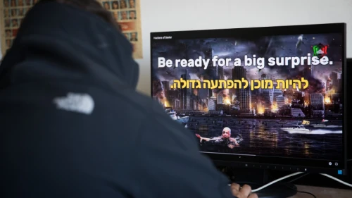 A man watches a video on an Israeli website hacked by a group calling itself the "Hacking Saviours" in an office in Jerusalem on May 21, 2020. Photo by Yonatan Sindel/Flash90.