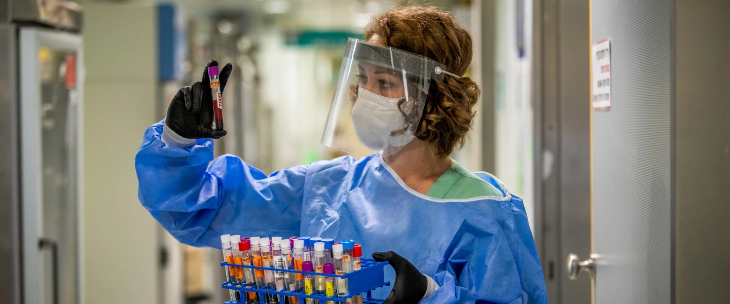 A technician carries out a diagnostic test for coronavirus in a lab at the Ichilov Hospital in Tel Aviv on Aug. 3, 2020. Photo by Yossi Aloni/Flash90.