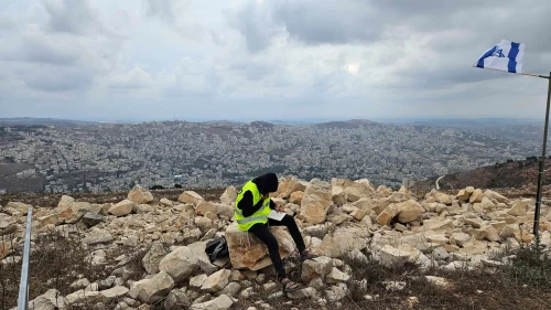 A yeshiva student learning Talmud overlooking Nablus during a tour at Joshua's Altar on Mt. Ebal in Samaria. Photo: Benjamin Sipzner.