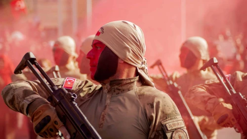 Turkish soldiers stand at attention as red smoke fills the air during Republic Day celebrations in Kayseri on Oct. 29, 2024. Photo by Damoun Pournemati/Middle East Images/AFP via Getty Images.