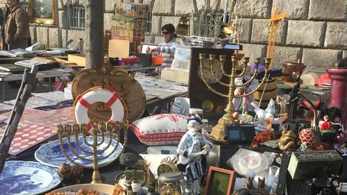 Two Hanukkah menorahs are pictured among other antiques at a flea market in Berlin. Credit: Orit Arfa.