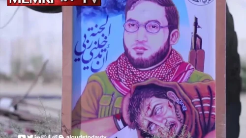 A poster in Gaza showing Hazem Yasser Arhim, an Al-Quds Brigades commander, holding the head of an Israeli soldier. (MEMRI)