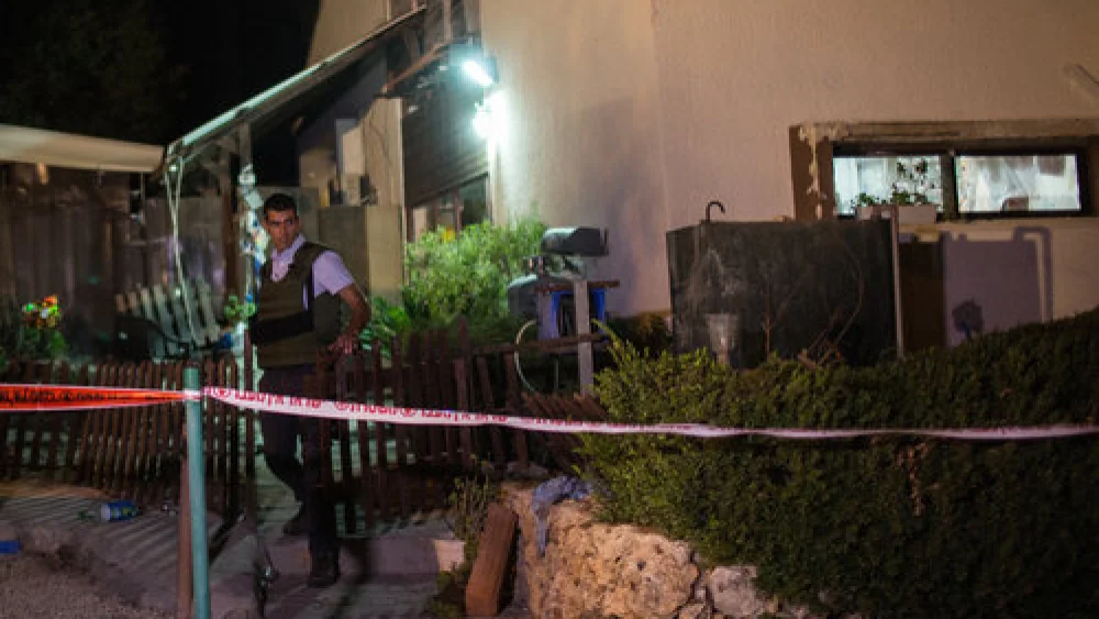 An Israeli security officer outside the home in Halamish where a Palestinian terrorist killed three members of an Israeli family July 21. Credit: Hadas Parush/Flash90.