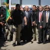 Palestinian Authority Prime Minister Rami Hamdallah, escorted by bodyguards, is greeted by Palestinian policemen upon his arrival in Gaza City on March 13, 2018. Credit: Abed Rahim Khatib/Flash90.