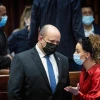 Israeli Prime Minister Naftali Bennett speaks with Knesset member Idit Silman in the plenary hall of the parliament in Jerusalem, Jan. 5, 2022. Photo by Yonatan Sindel/Flash90.