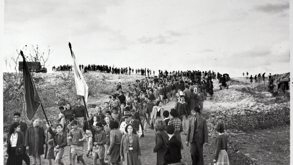 Young school children on their way to the tomb of Theodor Herzl, founder of Zionism, carrying placards and a banner that reads "If I Forget thee Jerusalem...". Credit: Lasar Dunner, Bettmann/Bettmann Archive. Photo dated to Sep. 2, 1949.