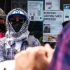 An anti-Israel protester wearing a keffiyeh mask and sunglasses in Brooklyn, N.Y., May 10, 2025. Photo by Madison Swart/Hans Lucas/AFP via Getty Images.
