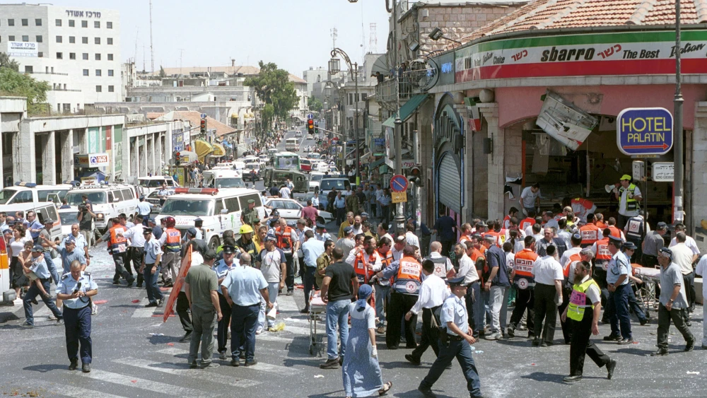 Israeli medics and volunteers treat the injured in the aftermath of the Sbarro pizzeria suicide bombing at the corner of King George Street and Jaffa Road in Jerusalem, on Aug. 9, 2001. Credit: Getty Images.
