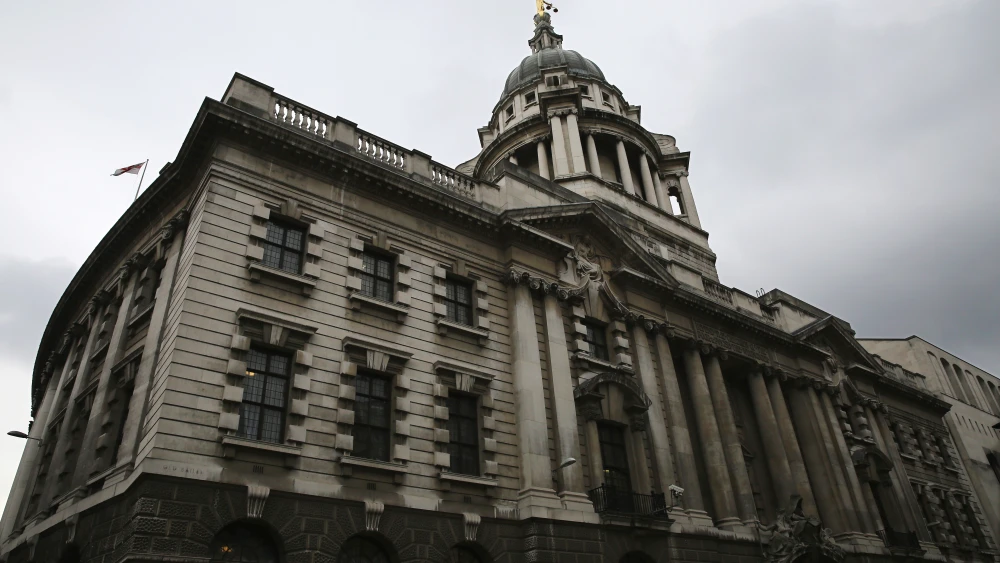 A statue of the scales of justice stands above the Old Bailey on February 16, 2015, in London, England. Photo by Dan Kitwood/Getty Images.