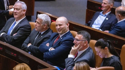 Israeli Foreign Affairs Minister Yair Lapid with Prime Minister Naftali Bennet (center) at the Knesset in Jerusalem on June 21, 2021. Photo by Olivier Fitoussi/Flash90.