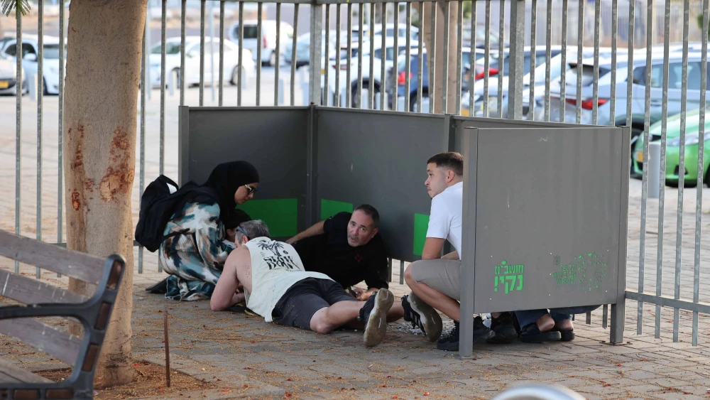 Israelis in Holon take cover as sirens warn of incoming missile fire from Lebanon, Oct. 14, 2024. Photo by Yossi Aloni/Flash90.