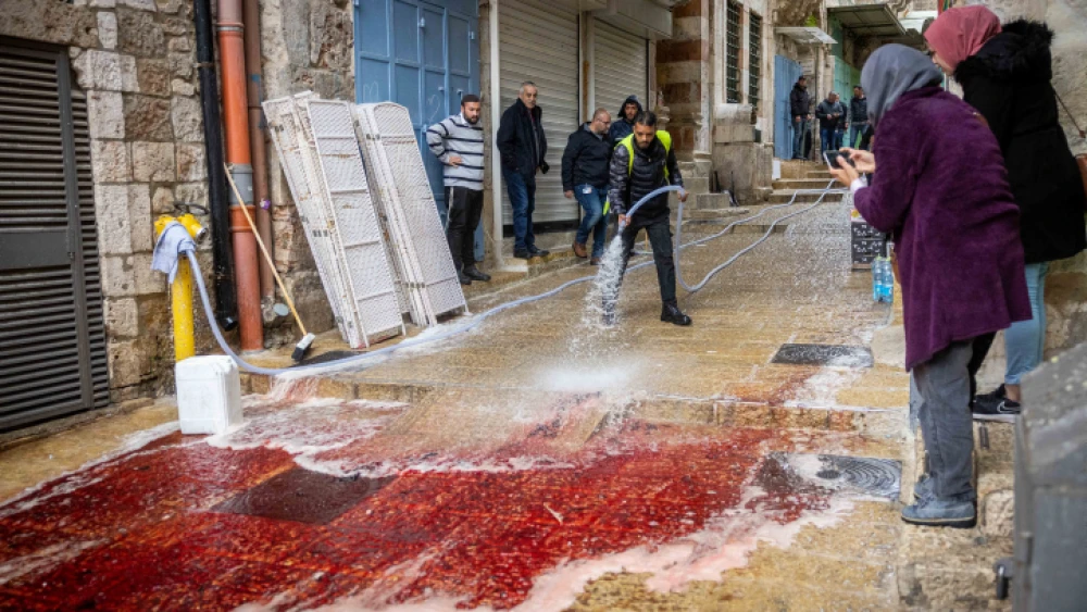 A worker cleaning the street at the scene of a terrorist attack in Jerusalem's Old City on Nov. 21, 2021. Photo by Yonatan Sindel/Flash90.