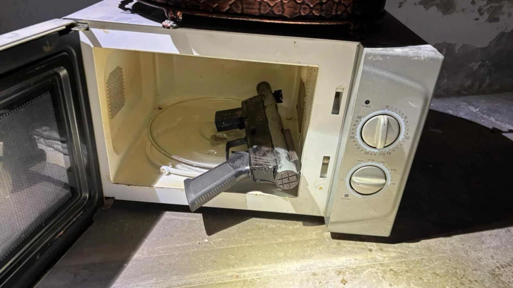 A gun in a microwave was one of the weapons found by the IDF's Samaria Regional Brigade on Nov. 19, 2025. Photo: IDF.
