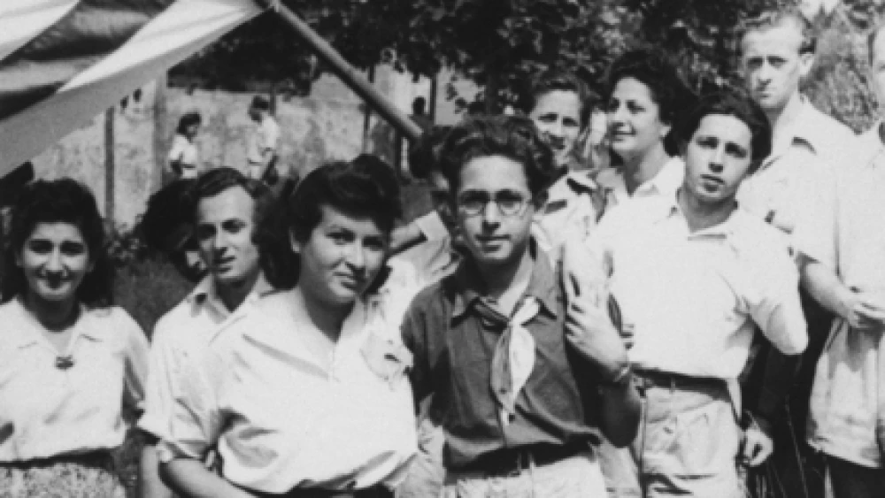 Akiva Kohane (front, wearing dark shirt) and a group of friends pose with a Zionist flag during a sports day in Tradate Italy. Kohane was a Haganah member during Israel's War of Independence. Credit: United States Holocaust Memorial Museum.