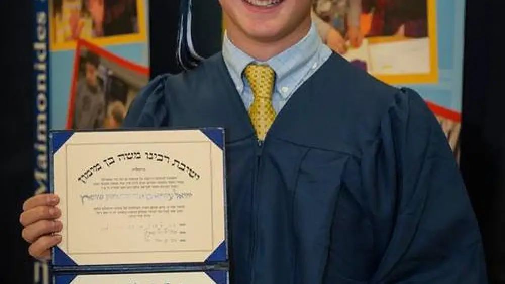 Click photo to download. Caption: Ezra Schwartz with his high school diploma from the Maimonides School in Brookline, Mass. Credit: Maimonides School via Facebook.