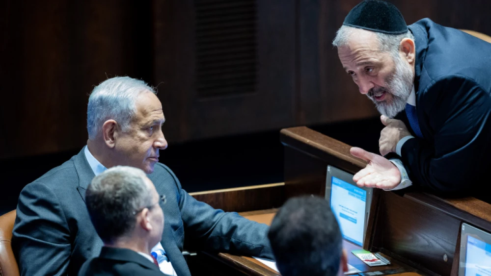 Israeli Prime Minister Benjamin Netanyahu speaks with Shas chairman Aryeh Deri in the Knesset. Photo by Yonatan Sindel/Flash90.