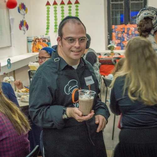 Yachad Israel member Rachamim Friedman serves at the cafe. Credit: Yachad.