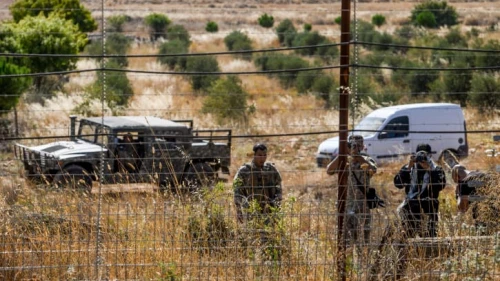 Lebanese soldiers and Hezbollah fighters taking pictures during a fire that spread from the Lebanese side of the border to the Israeli side of the border in Kibbutz Malkia, northern Israel, July 28, 2023. Photo by Ayal Margolin/Flash90.