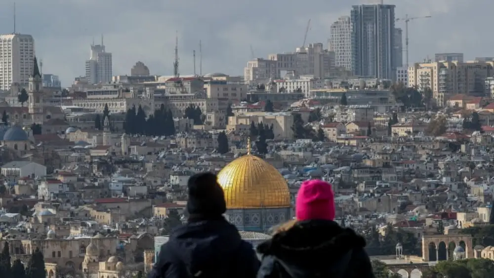 Tourists at a lookout point on the Mount of Olives gaze down on the Temple Mount and the Old City of Jerusalem, Feb. 8, 2023. Photo by Jamal Awad/Flash90.