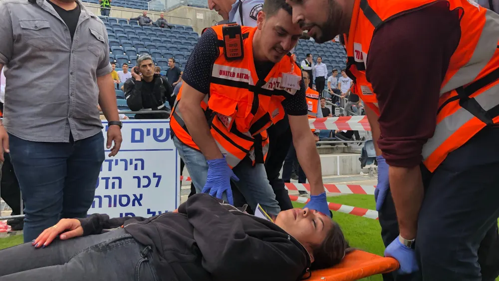 United Hatzalah emergency personnel treating a patient at a mass-casualty simulation at Teddy Stadium in Jerusalem. Photo by Eliana Rudee.