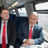 Minister of Transportation Israel Katz (left) and Israeli Prime Minister Benjamin Netanyahu take a test drive of the Jerusalem-Tel Aviv express train in central Israel on Sept. 20, 2018. Photo by Noam Revkin Fenton/Flash90.