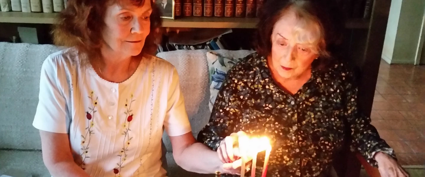 Margery B. Sterns (right), 96, a a longtime resident of San Francisco, lights the menorah with her daughter Sandra. Margery recalls her Russian immigrant parents lighting the menorah as one of her top memories of Hanukkah. Credit: Courtesy.