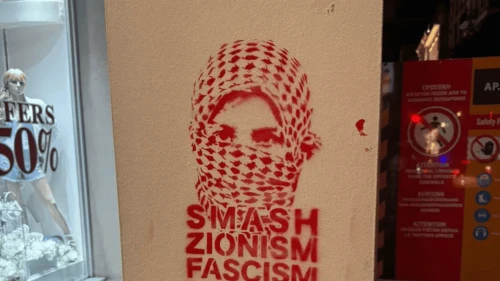 Graffiti sprayed on the facade of the King David Burger restaurant in Athens on July 12, 2025. Credit: Courtesy of Zvika Levinson.