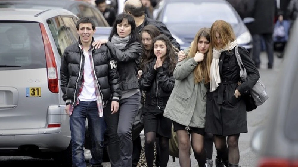 Distressed teenagers walk away from the Ozar Hatorah Jewish school in Toulouse, France, on March 19, 2012, where a man opened fire and killed a 30-year-old teacher and three young children, age 3, 6 and 10. Credit: EPA/MAXPPP/XAVIER DE FENOYL.
