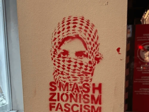 Graffiti sprayed on the facade of the King David Burger restaurant in Athens on July 12, 2025. Credit: Courtesy of Zvika Levinson.