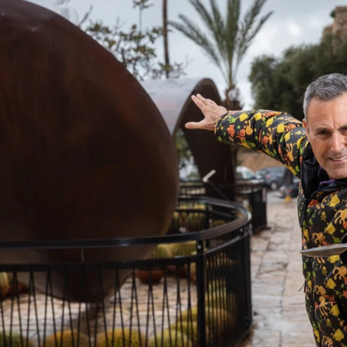 Uri Geller next to a giant bent spoon outside his museum in Jaffa. Photo by Hadas Parush/Flash90.